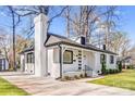 Beautifully renovated white brick home with black trim and a well maintained lawn at 5009 Milford Rd, Charlotte, NC 28210