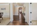 Spacious foyer showcasing hardwood floors, elegant trim, and arched doorways to other living spaces at 5059 Saint Clair St, Fort Mill, SC 29715