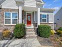 Close-up of the home's entrance, showcasing the welcoming red door and landscaped stairs at 5059 Saint Clair St, Fort Mill, SC 29715