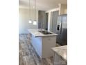 Modern kitchen island featuring a stainless steel sink, faucet, and elegant marble countertops at 565 Perry Rd # 9, Troutman, NC 28166
