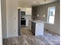 Bright kitchen boasts stainless steel appliances, white cabinets, and a stylish island with marble countertops at 565 Perry Rd # 9, Troutman, NC 28166
