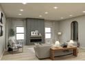 Bright living room with fireplace, modern decor, and sleek hardwood floors at 706 Falling Oak Aly, Huntersville, NC 28078