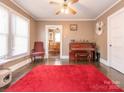 Inviting room with hardwood floors, a ceiling fan, and view into the dining area for easy entertaining at 707 Oakshade Ave, Kannapolis, NC 28083