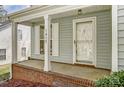 Close-up of the front porch, featuring a brick base, white columns, and the house number 7815 on the side at 7815 Ambleside Dr, Charlotte, NC 28216