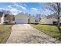 Inviting one-story home features attached garage and extended driveway at 959 Avery Ct, Concord, NC 28025