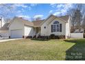 Charming one-story home with vinyl siding, attached garage, and well-maintained front yard at 959 Avery Ct, Concord, NC 28025