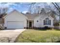 Charming single-story home featuring a well-maintained lawn, attached garage, and inviting front porch at 959 Avery Ct, Concord, NC 28025