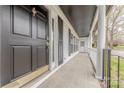Welcoming front porch with tiled flooring, classic columns, and a charming entryway at 10101 Woodview Cir, Charlotte, NC 28277