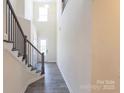 Entryway featuring a staircase and a view of the front door and wood-look floors at 104 Kentmore Dr, Waxhaw, NC 28173