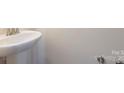 Close up of a pedestal sink and faucet in a half bath at 104 Kentmore Dr, Waxhaw, NC 28173
