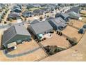 Aerial view of a landscaped backyard with a patio, surrounded by lush greenery and a black metal fence at 11124 Chapeclane Rd, Charlotte, NC 28278