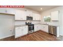 Bright kitchen featuring white cabinets, granite countertops, and stainless steel appliances at 11220 Cardinal Creek Ave, Charlotte, NC 28215