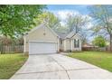 Inviting single-story house with a neat front yard and a convenient two-car garage at 11404 Larix Dr, Charlotte, NC 28273