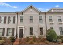 Charming townhome featuring neat landscaping, light gray siding, and dark brown shutters with an inviting entrance at 118 Mint Ave # B, Mooresville, NC 28117