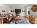 Relaxing living room featuring warm hardwood floors, a vintage rug, and large windows at 118 Mint Ave # B, Mooresville, NC 28117