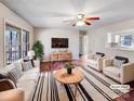 Bright living room with hardwood floors, a ceiling fan, and neutral paint colors, perfect for entertaining and relaxing at 1420 Hickory Nut Ln, Lincolnton, NC 28092