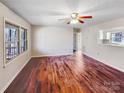 Spacious living room boasts hardwood floors, a ceiling fan and a large window allowing natural light to fill the space at 1420 Hickory Nut Ln, Lincolnton, NC 28092