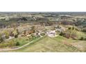 Wide aerial shot of an estate displaying several structures, lush greenery, and a serene countryside setting at 1620 London Rd, Mooresville, NC 28115