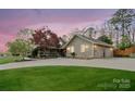 Charming home with a spacious driveway, well-manicured lawn, and picturesque landscaping at 1620 London Rd, Mooresville, NC 28115