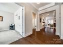 Bright hallway with hardwood floors leading to an office space and living room at 17436 Langston Dr, Charlotte, NC 28278