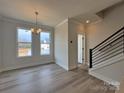 Bright living room featuring sleek flooring, large windows, and a modern staircase at 2043 Clarksdale St # 31, Charlotte, NC 28206