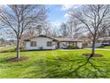 Charming single-story home featuring manicured lawn and mature trees at 2052 10Th Street Nw Pl, Hickory, NC 28601