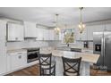 Well-lit, modern kitchen with white cabinetry, an island, and stainless steel appliances at 2052 10Th Street Nw Pl, Hickory, NC 28601