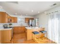 Eat-in kitchen featuring wood cabinets, stainless appliances, and bar seating, perfect for casual dining at 2249 Cigar Ct, Charlotte, NC 28273