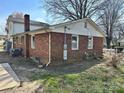 Brick home exterior showing utility connections and partial landscaping at 314 N Little Texas Rd, Kannapolis, NC 28083