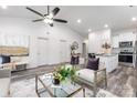 Open-concept living room with vaulted ceiling, ceiling fan, and hardwood flooring at 324 Piedmont Ave, Mount Holly, NC 28120
