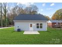 The rear exterior of the home showing the lawn, patio and siding at 324 Piedmont Ave, Mount Holly, NC 28120
