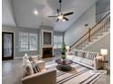 Bright living room with vaulted ceiling, fireplace, and staircase at 3865 Granite St, Terrell, NC 28682