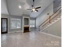 Spacious living room showcasing tiled floors, fireplace, and staircase at 3865 Granite St, Terrell, NC 28682