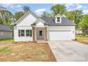 Inviting home with a well-manicured lawn, a classic white facade, and a convenient attached two-car garage at 402 Walker St, Kannapolis, NC 28081