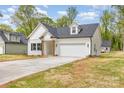 A cozy single-Gathering home boasting classic architecture, a well-kept lawn, and an attached garage for convenience at 402 Walker St, Kannapolis, NC 28081