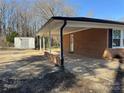 Spacious carport of brick home, offering covered parking and convenient access to the backyard at 418 Dallas Stanley Hwy, Dallas, NC 28034