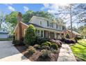 Charming two-story home featuring brick accents, stone walkway and lush landscaping at 6117 Brace Rd, Charlotte, NC 28211