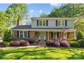 Inviting two-story home with brick facade, shutters, and landscaped front yard at 6117 Brace Rd, Charlotte, NC 28211