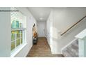 Bright hallway with luxury vinyl floors, white trim, a staircase, and a window with natural light at 816 N Naughton St, Chester, SC 29706