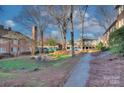 Condo complex with trees, green space, courtyard sitting area and convenient parking at 101 S Laurel Ave # 72A, Charlotte, NC 28207