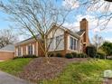 Brick home with a chimney and well-manicured landscaping showcasing its suburban charm at 11406 Olde Turnbury Ct, Charlotte, NC 28277