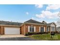 A well kept brick home with attached garage and a beautifully manicured lawn at 11406 Olde Turnbury Ct, Charlotte, NC 28277
