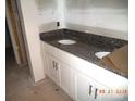 Bathroom features a double sink vanity with granite countertop at 122 Peppervine Ln, Statesville, NC 28625
