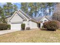 Charming single-Gathering home featuring a well-maintained front yard and a two-car attached garage at 12810 English Walnut Ln, Charlotte, NC 28215