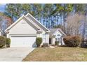 Charming single-Gathering home featuring a well-maintained front yard and a two-car attached garage at 12810 English Walnut Ln, Charlotte, NC 28215