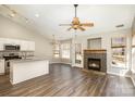 Bright and open living space with hardwood floors and a cozy fireplace, adjacent to the modern kitchen at 12810 English Walnut Ln, Charlotte, NC 28215