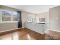 Dining area with a built-in cabinet, stylish lighting, and hardwood floors at 1525 16Th Avenue Nw Cir, Hickory, NC 28601