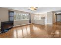 Bright living room featuring hardwood floors, large windows, and a built-in storage area at 1525 16Th Avenue Nw Cir, Hickory, NC 28601