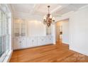 Bright dining room featuring hardwood floors, a stylish chandelier, and custom built-in cabinetry at 1730 Townsend Ln, Rock Hill, SC 29730