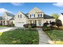 Charming two-story home with a manicured lawn, attached garage, and inviting front porch at 1730 Townsend Ln, Rock Hill, SC 29730
